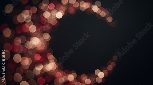 Abstract crescent shape of warm glowing bokeh lights