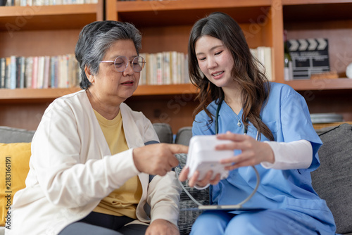 Canvas Print Caring nurse helps senior woman with medication at home showing attentive emotio