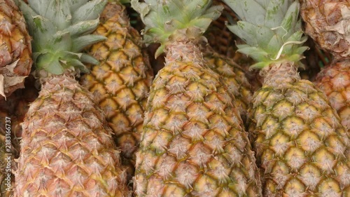Group of fresh pineapples displaying their textured skin and green crowns