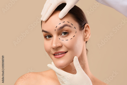 Fotografie Plastic surgery and cosmetic procedure, surgeon hands examining woman face with