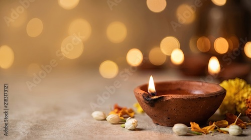 Diya oil lamp burning with flower decoration for diwali festival celebration