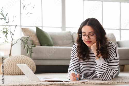 Female Indian student studying online at home