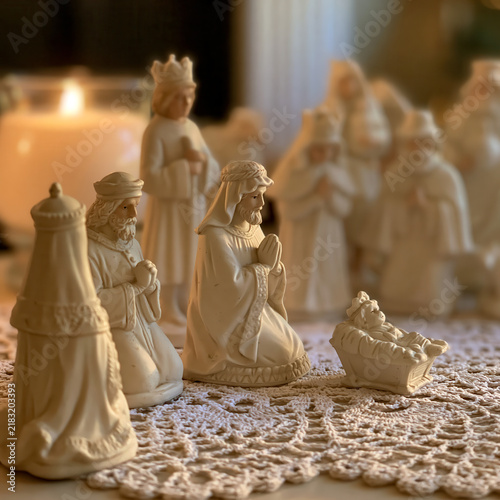 Porcelain nativity set displayed on lace doily from family heirloom