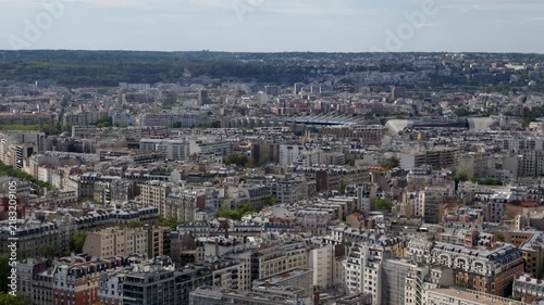 Panoramic aerial view of Paris cityscape with buildings and rooftops extending to the horizon