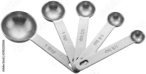 Bild auf Leinwand Five stainless steel measuring spoons on black surface.
