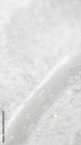 Vertical serum gel background, macro transparent cream texture, facial mask