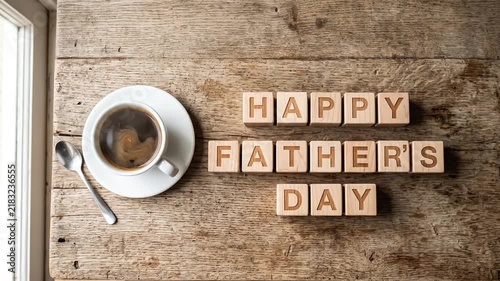 Happy Fathers Day greeting with wooden letter blocks and coffee cup