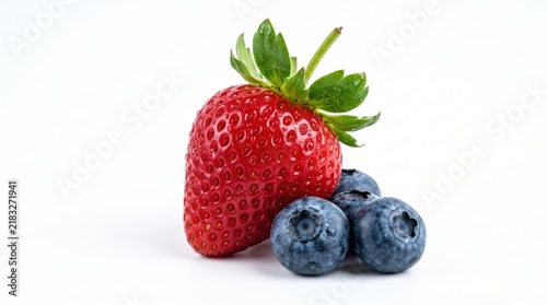 Fresh red strawberry and ripe blue blueberries sitting together