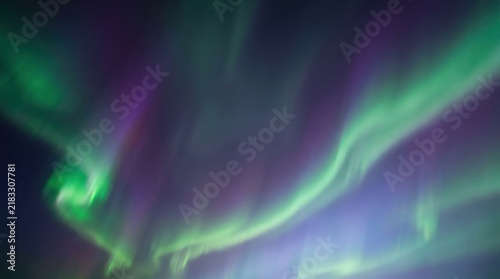 Aurora Borealis Background with Flowing Green Violet Light Waves