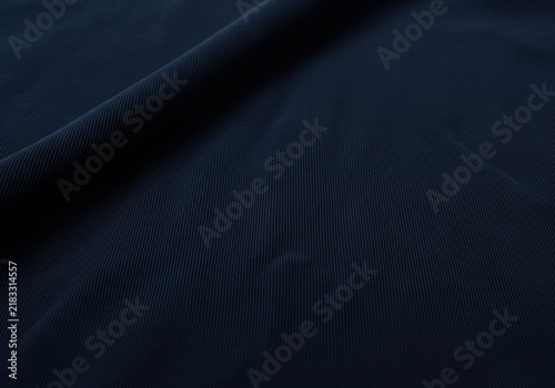 Deep dark navy blue fabric texture background.