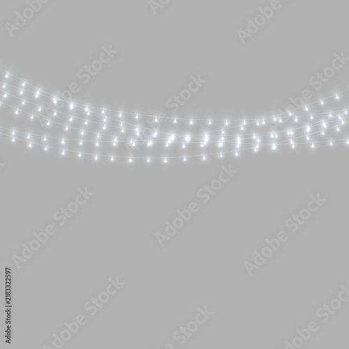Quadro su tela A series of small white string lights hanging on multiple curved lines