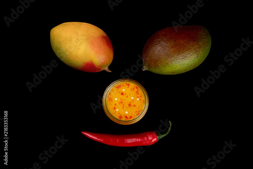 Mango on black. Chili on black. Face