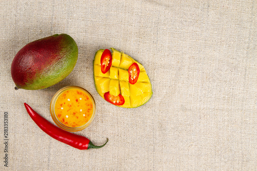 Mango chili sauce, mango and chili on burlap.