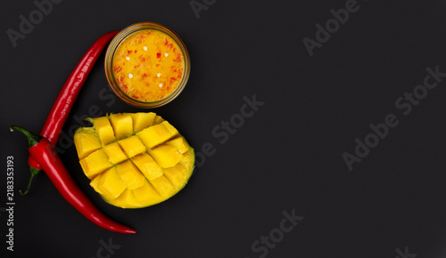 Mango on black. Chili on black. Mango chili sauce.