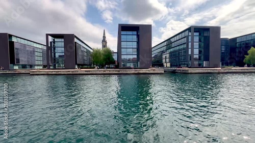 Boat trip perspective of the Christiansbro modern office complex along the canal in Copenhagen, Denmark, showcasing its distinctive contemporary architecture and glass facades - stock video