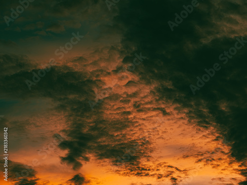 Obraz na plátně Intense Fiery Orange Sunset Clouds with Dark Brooding Storm Texture