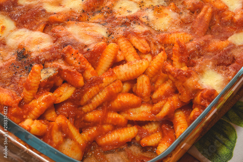 Baked malloreddus with tomato sauce, sausage and provola cheese