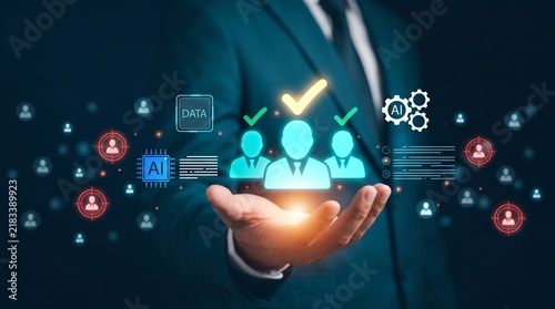 Businessman holding digital human resource and artificial intelligence interface icons in his open palm