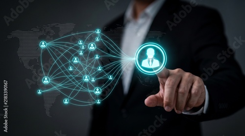 A businessman touching a digital holographic user network interface with a world map background with connection