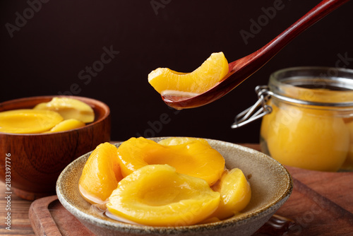 Canned Peach Slices in Bowl with Spoon