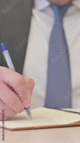 Hands Close Up of Businessman Writing on Notebook, Vertical Video