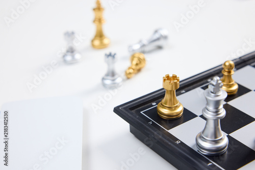 Foto Chess Pieces on Board with Strategic Game Setup