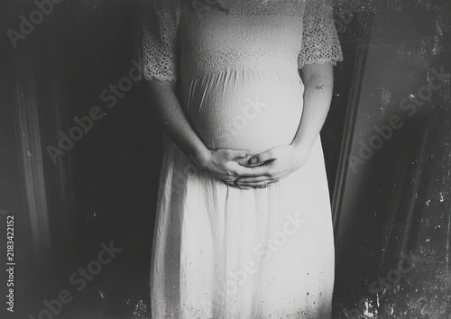 Black and White Picture of Pregnant Woman in White Dress. Generative AI