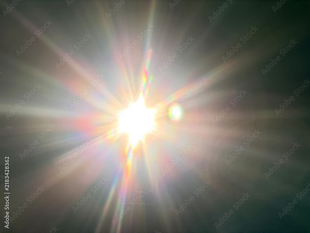 Konstfotografi Bright sun flare with rainbow diffraction rays