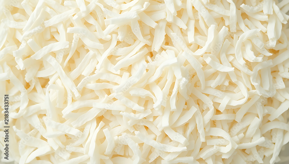 Fototapeta premium Close Up Dried Shredded Coconut Flakes Macro Bakery Ingredient Background