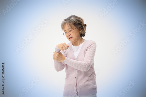 фотографія Senior woman clutching wrist in pain
