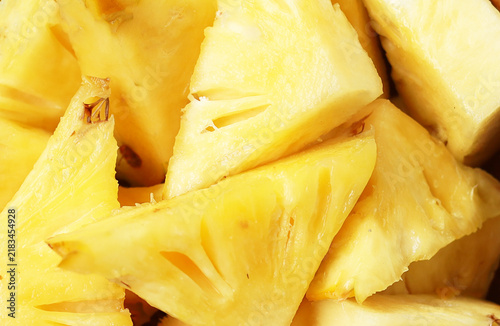 Fresh, ripe triangular pineapple pieces on white background