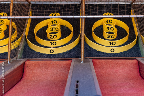 Score rings at a carnival game in an amusement park during the daytime