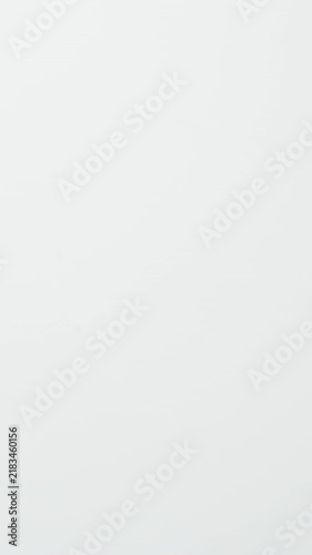 MACRO: Male fingers takes a yellow condom from a white table - Top view