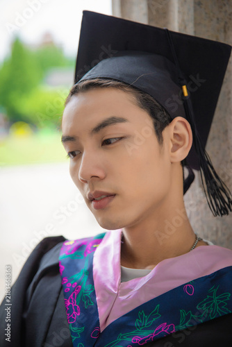Canvas Print Portrait of Young East Asian Graduate in Academic Regalia