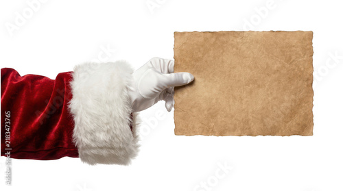 Santa claus hand holding a blank brown paper for a holiday sign isolated on transparent background