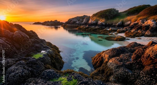 Sunset over rocky coastal cliffs and water