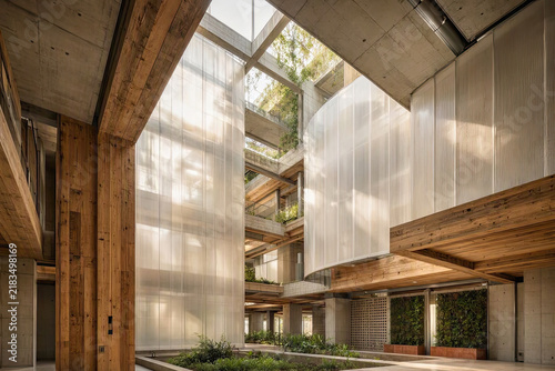 Sustainable brutalist interior with reclaimed wood and recycled composite materials.