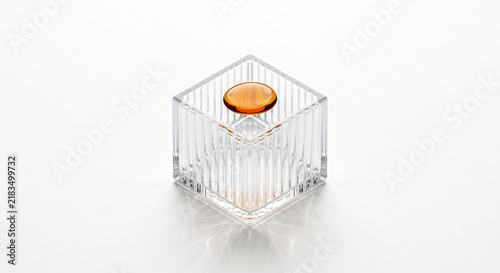 Isometric view of ribbed fluted glass block cradling amber botanical oil droplet