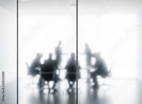 Blurred Silhouettes of Business Team Meeting in Conference Room, Blurry People Behind Frosted Glass Wall, Abstract Corporate Collaboration and Privacy Concept