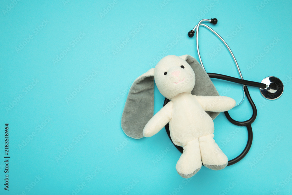 Obraz premium Pediatrician concept. Toy bunny and stethoscope on blue background.