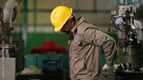Industrial Factory Worker Suffering from Severe Lower Back Pain
