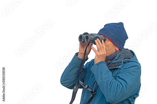A close-up image of a man—isolated against a transparent background, wearing a blue jacket and a beanie—observing nature through binoculars. A passion for wildlife.