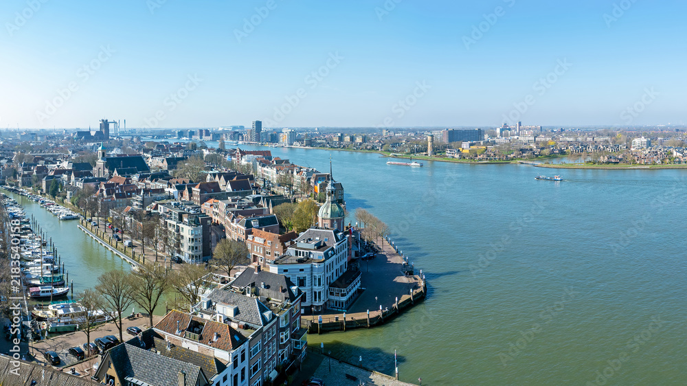 Obraz premium Historic riverside city with prominent waterfront landmark in Europe