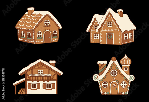 Set of four festive gingerbread houses with snow on the roofs isolated on black background