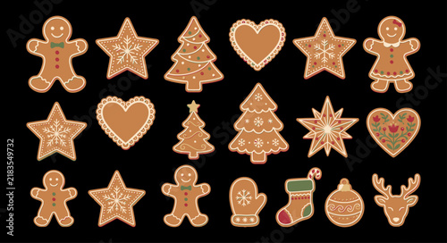 Assorted christmas gingerbread cookies with icing decoration isolated on a dark black background top view