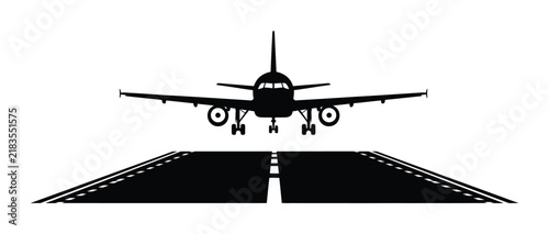 Black silhouette of a airplane landing on an airport runway