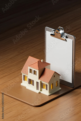 Premium Corporate 3D Real Estate Concept Featuring a White Plastic Miniature House and Blank Property Checklist on Wooden Desk for Home Inspection and Investment Planning
