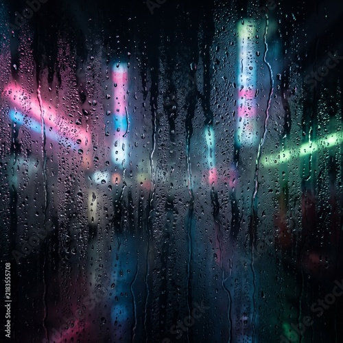 Macro shot of frosted glass with water condensation, dark moody background with blurred cyberpunk city neon lights, cinematic lighting