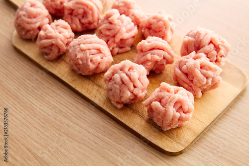 Cuadro en lienzo Raw Minced Meatballs on Wooden Cutting Board
