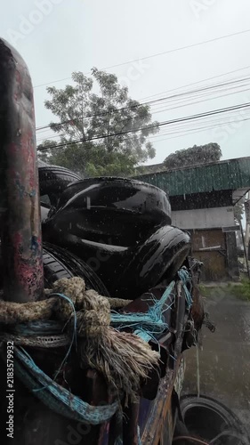 Rain falling on a weathered fishing boat
